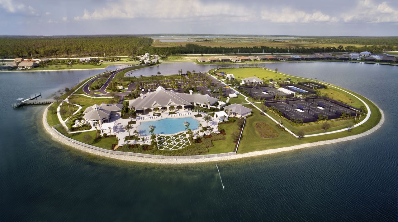 Aerial view of a coastal resort complex on a small island surrounded by water.