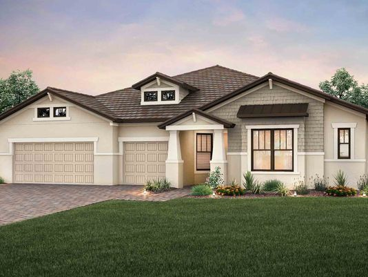 A modern single-story suburban house with a two-car garage and landscaped front yard under a partly cloudy sky.