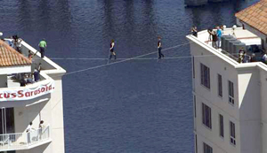 People are walking on a large flat roof between buildings.